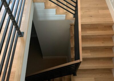 hardwood stairs with black iron accent