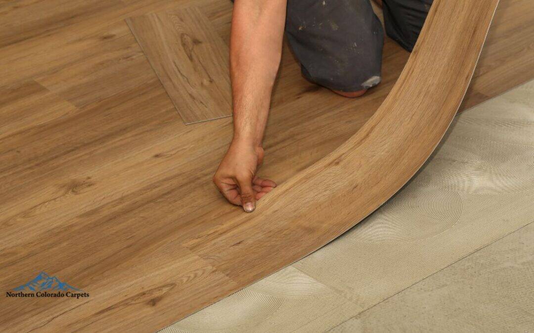 A team member of Norther Colorado Carpets installing new vinyl flooring.
